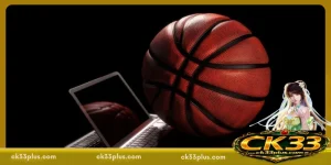 Basketball placed near an open laptop symbolizing digital sports interaction